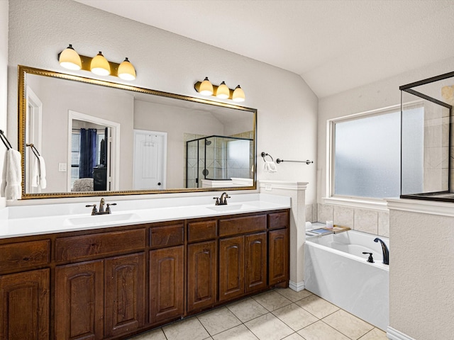 bathroom with lofted ceiling, vanity, tile patterned floors, and shower with separate bathtub