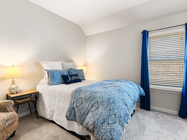 bedroom featuring carpet and lofted ceiling