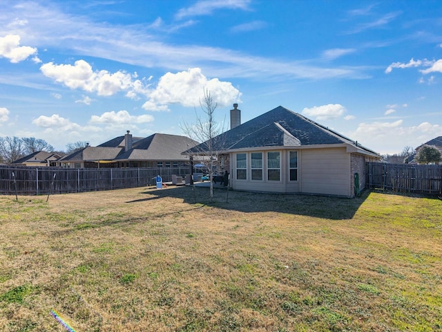 back of house with a yard