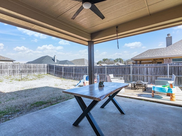 view of patio / terrace with a fire pit and ceiling fan