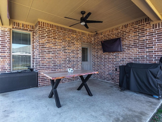 view of patio featuring area for grilling, radiator heating unit, and ceiling fan