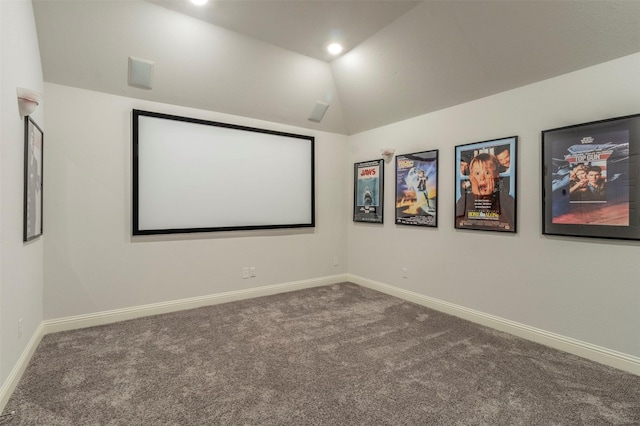 carpeted home theater room with lofted ceiling