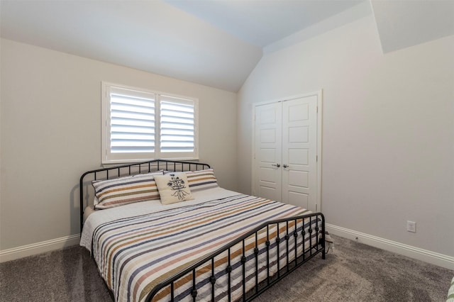 carpeted bedroom with vaulted ceiling and a closet