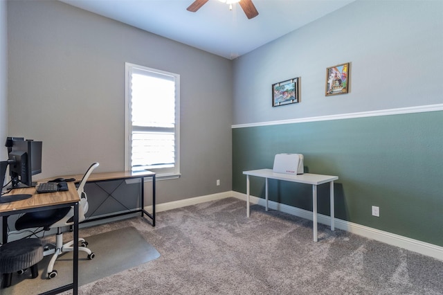 carpeted home office featuring ceiling fan