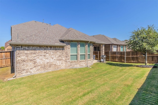 rear view of house with a yard