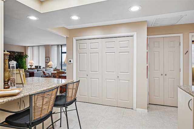 kitchen featuring light stone countertops and light tile patterned floors