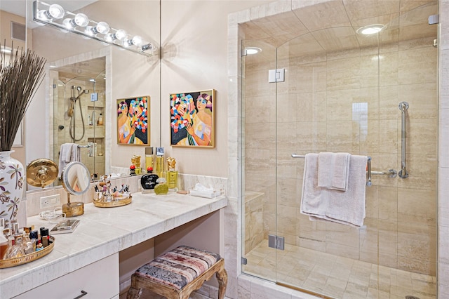 bathroom with vanity and a shower with shower door