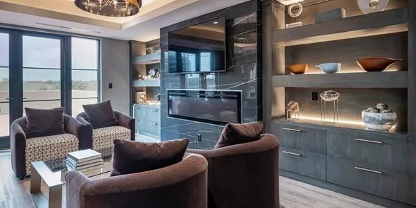 living area featuring built in shelves and light hardwood / wood-style floors