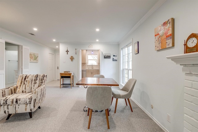 carpeted dining area featuring ornamental molding and sink