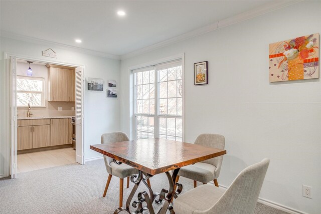 dining space with crown molding, a fireplace, and carpet floors