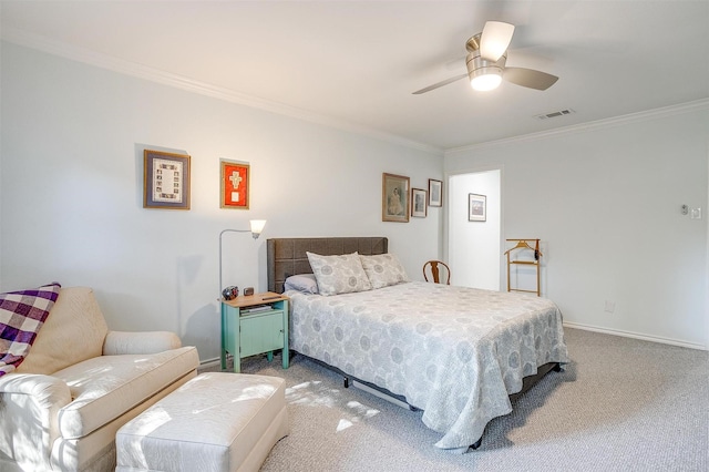 carpeted bedroom with ornamental molding and ceiling fan