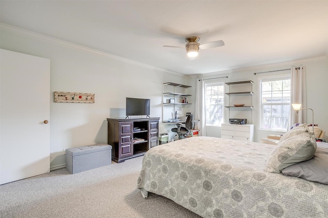 carpeted bedroom featuring crown molding and ceiling fan