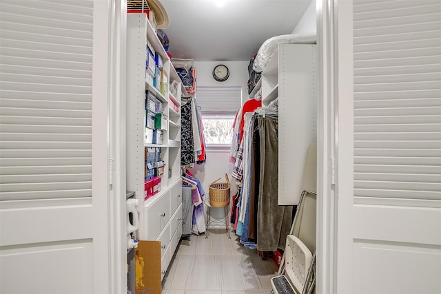 spacious closet with light tile patterned floors