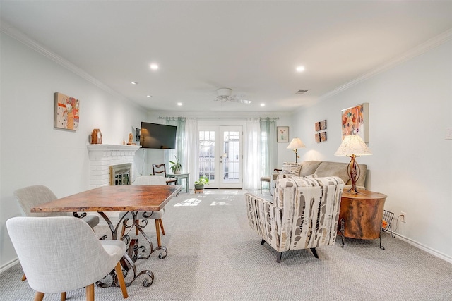 living room with french doors, ornamental molding, and light carpet