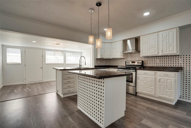 kitchen featuring wall chimney exhaust hood, sink, white cabinetry, electric range, and a kitchen island