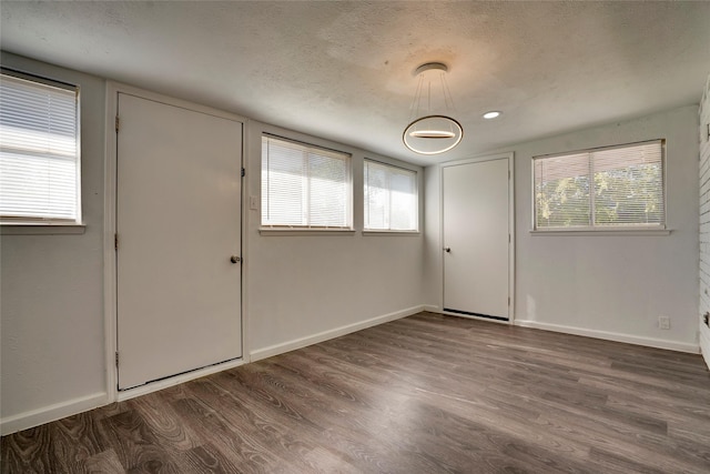 entrance foyer featuring dark hardwood / wood-style floors and a textured ceiling