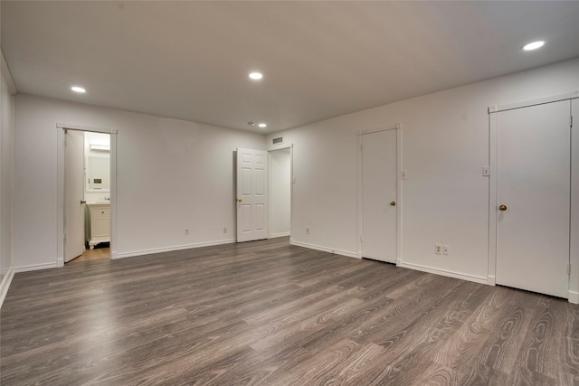 empty room with dark hardwood / wood-style floors