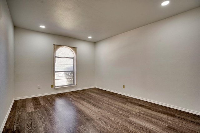 spare room featuring dark hardwood / wood-style flooring