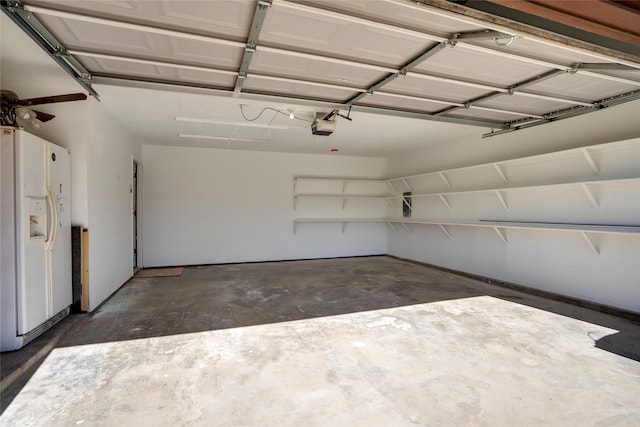 garage with a garage door opener and white fridge with ice dispenser