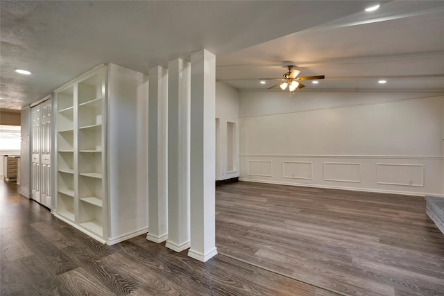 interior space with dark wood-type flooring and ceiling fan