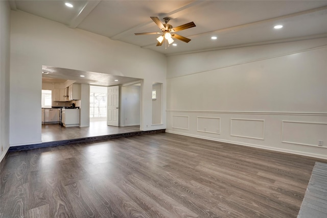 unfurnished living room with dark hardwood / wood-style floors and ceiling fan