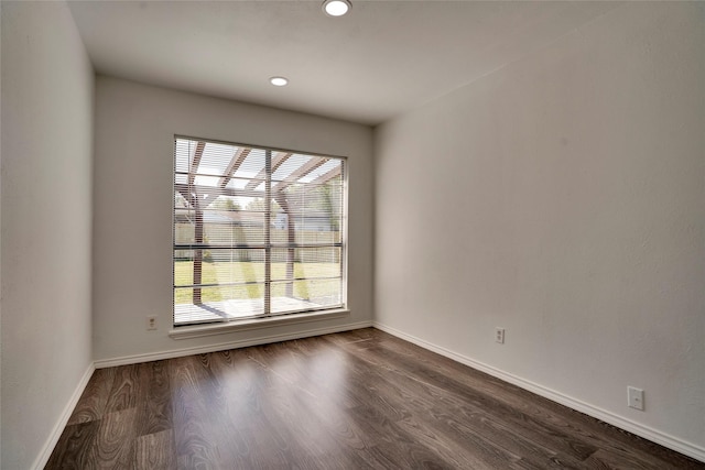 empty room featuring dark hardwood / wood-style flooring