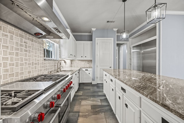 kitchen with range with two ovens, white cabinetry, sink, and wall chimney exhaust hood