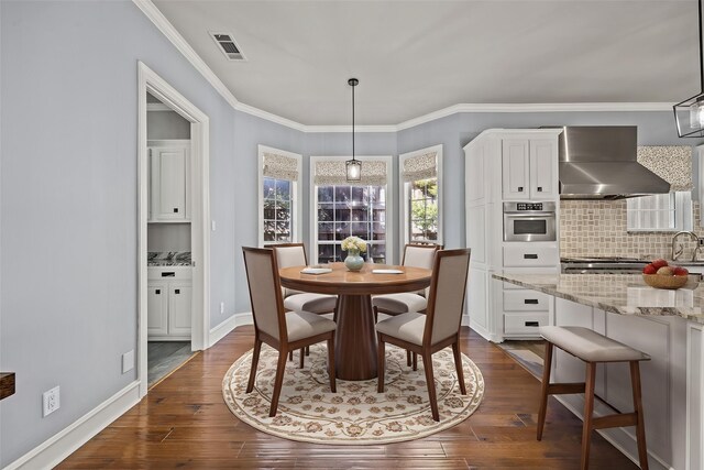 5008 Bellerive Dr, Dallas, TX 75287 - dining space featuring dark wood-style floors, ornamental molding, and baseboards