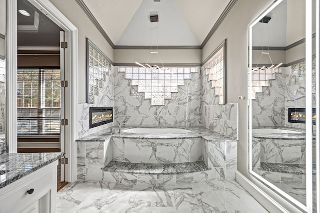 5008 Bellerive Dr, Dallas, TX 75287 - full bathroom featuring a glass covered fireplace, marble tiled floors, a garden tub, lofted ceiling, and a chandelier