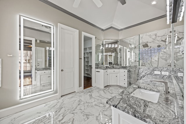 bathroom with lofted ceiling, vanity, ornamental molding, ceiling fan, and a shower with door