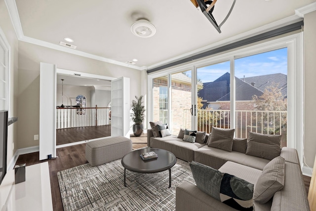 living room with ornamental molding, wood-type flooring, and a mountain view