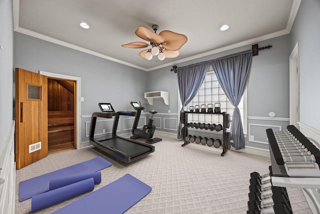 exercise room featuring ornamental molding, carpet, and ceiling fan