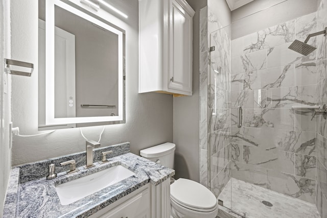 bathroom featuring vanity, toilet, and an enclosed shower