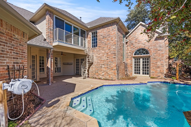 view of swimming pool featuring a patio, french doors, and ceiling fan