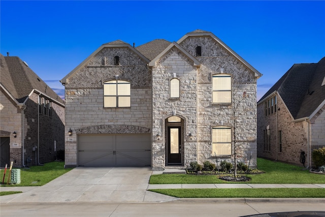 french provincial home with a garage and a front yard