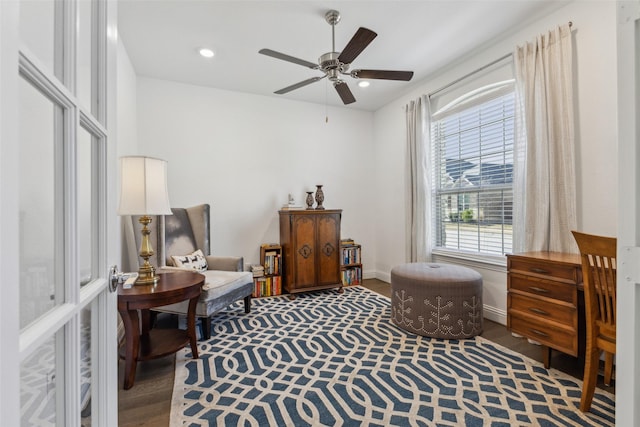 living area with ceiling fan and wood-type flooring