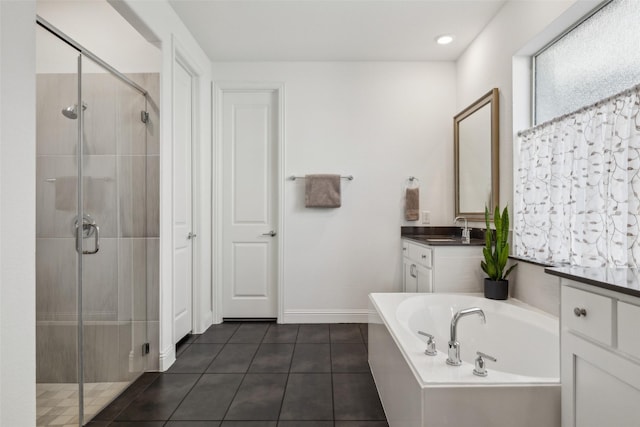 bathroom with tile patterned flooring, shower with separate bathtub, and vanity