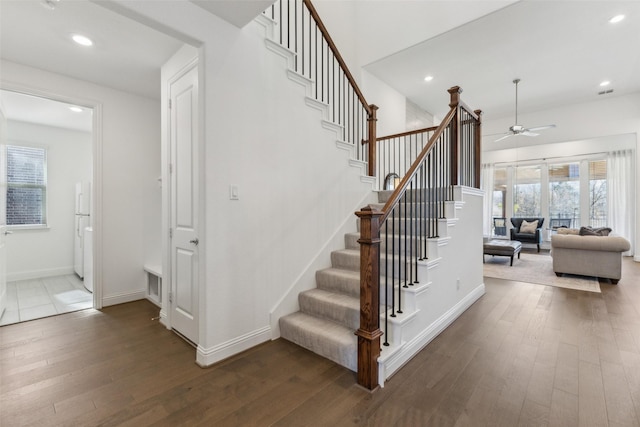 stairway featuring wood-type flooring and ceiling fan