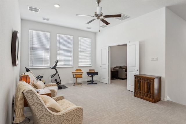 sitting room featuring light carpet and ceiling fan