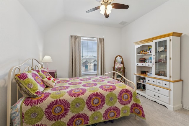 carpeted bedroom with vaulted ceiling and ceiling fan