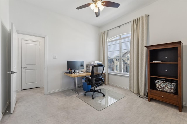 carpeted office space featuring ceiling fan