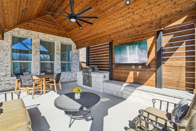 view of patio featuring a grill, ceiling fan, and exterior kitchen