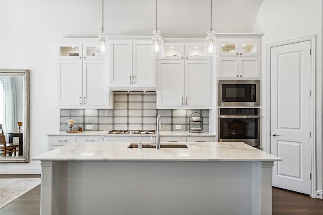 kitchen featuring pendant lighting, stainless steel appliances, and white cabinets