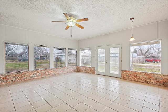 unfurnished sunroom featuring french doors and ceiling fan