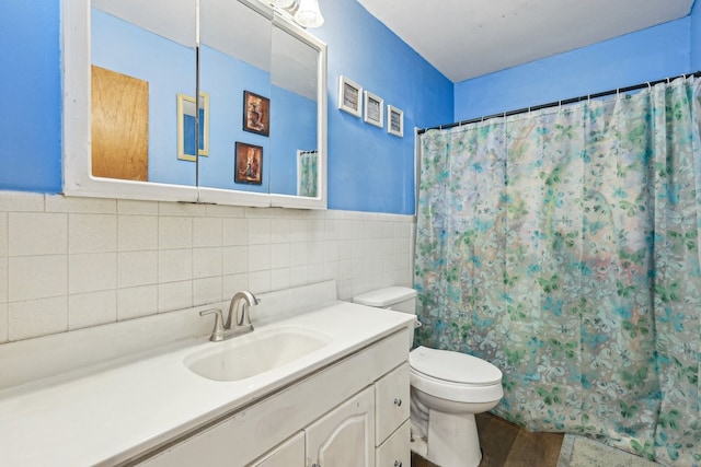 bathroom featuring vanity, toilet, a shower with shower curtain, and tile walls