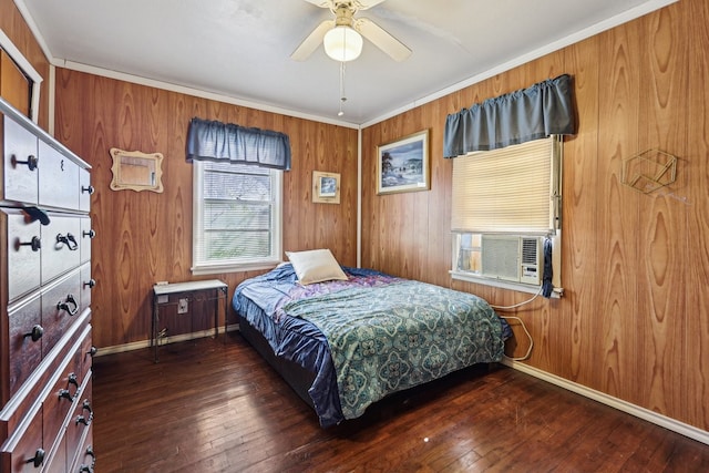 bedroom featuring ceiling fan, dark hardwood / wood-style floors, cooling unit, and wooden walls