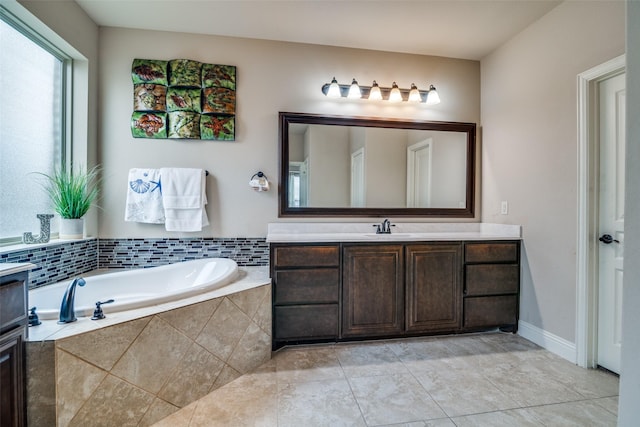 bathroom with vanity and a relaxing tiled tub