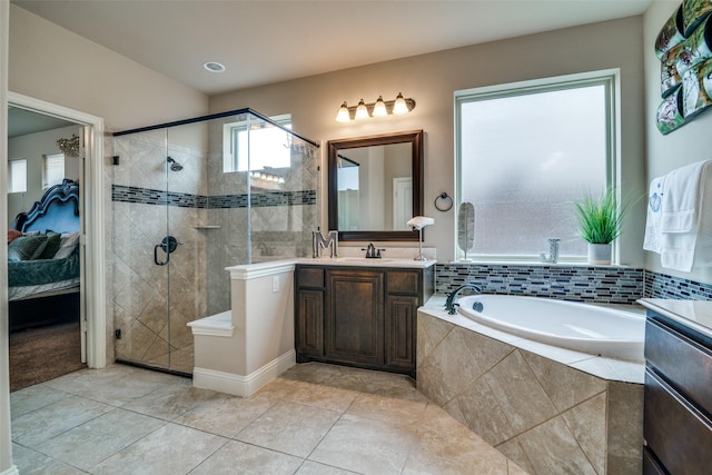 bathroom featuring vanity, tile patterned flooring, and shower with separate bathtub