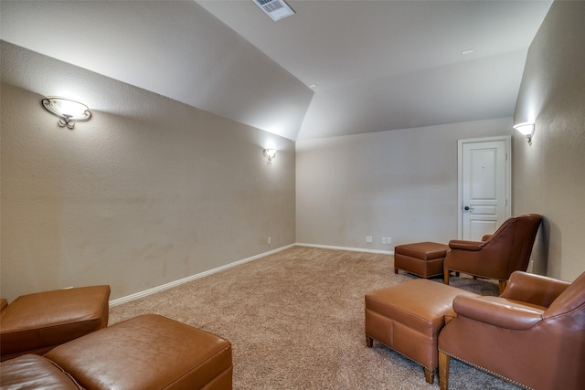 carpeted home theater with vaulted ceiling