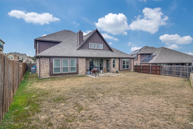 back of house with a patio and a yard